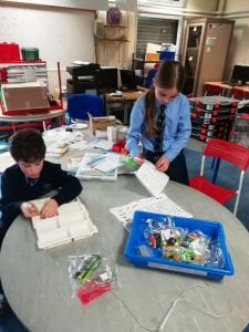 Ninjas get busy setting up the component trays for LEGO WeDo kits